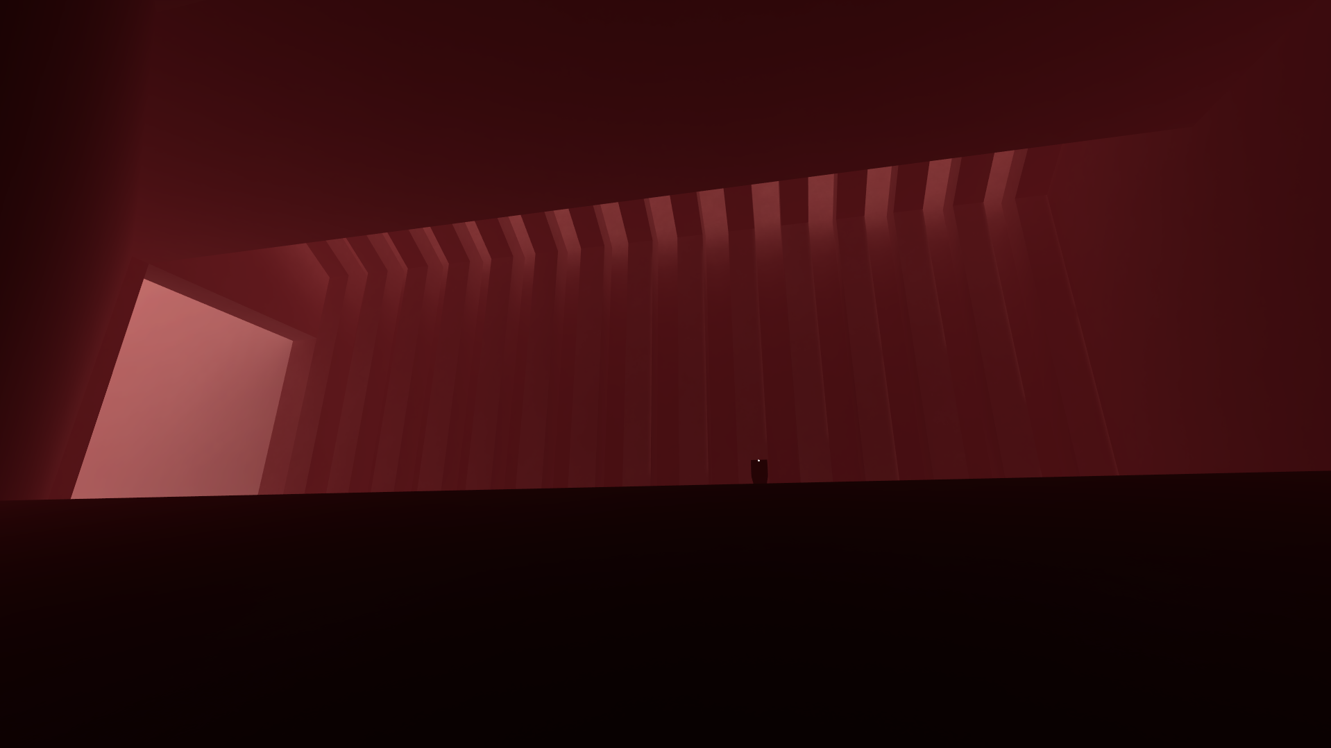 Big and red. A view from inside a dark structure, the sky red.